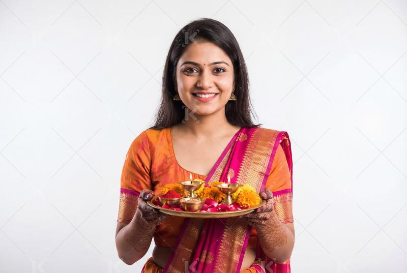 Young indian woman wearing sari celebrating akshay tritiya at ho