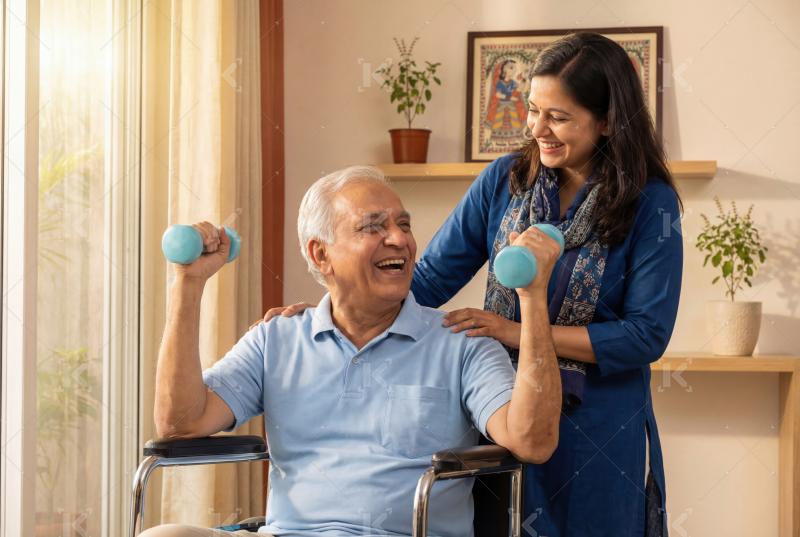 An elderly man happily exercises with dumbbells in a wheelchair