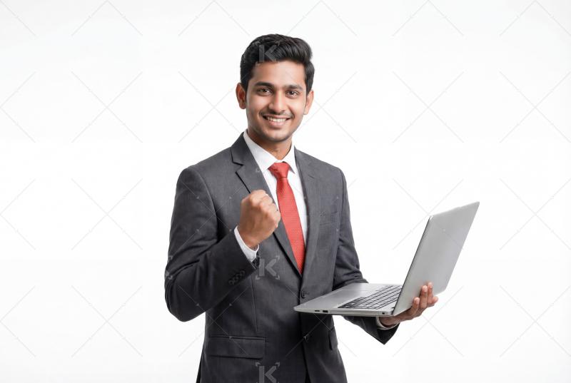 A confident young professional in a suit smiles while holding a