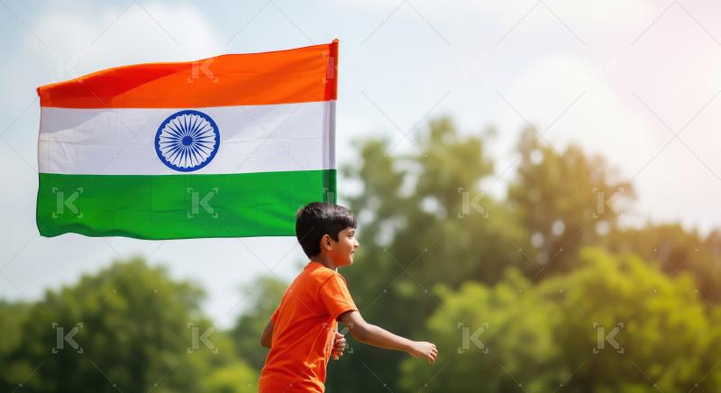A little boy in an orange shirt runs with the Indian flag