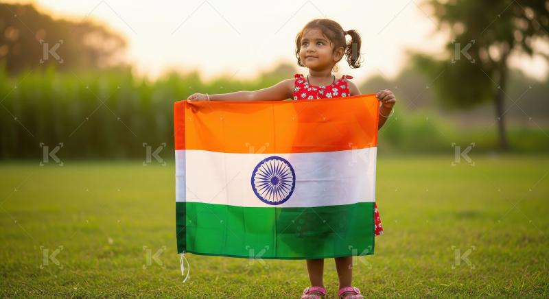 Indian little girl proudly holding indian national flag