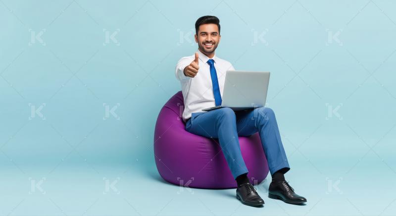 Happy Businessman Thumbs Up Working on Laptop on Bean Bag