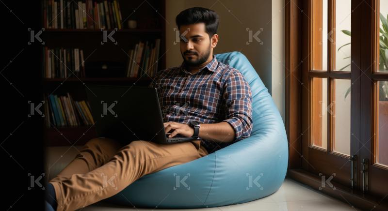 Young man focused on laptop in cozy home setting