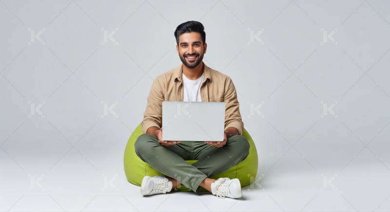Young Man Smiling, Working on Laptop on Bean Bag