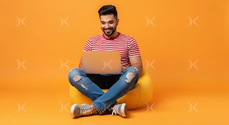 Joyful Man Using Laptop, Sitting on Beanbag