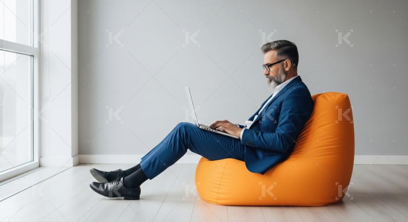 Focused businessman works comfortably on laptop in modern office