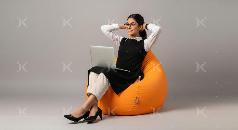 A confident businesswoman in a black-and-white formal dress rela