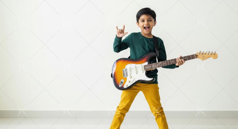 Happy indian boy playing guitar