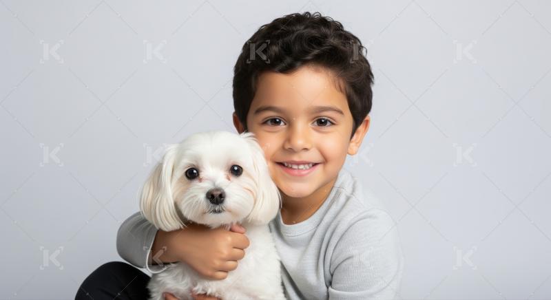A cheerful child lovingly holds his cute furry companion.