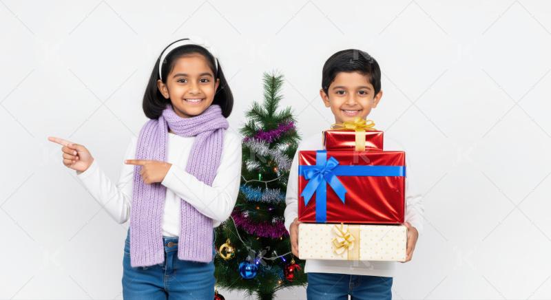 Girl in a Santa hat and a boy sit by a Christmas tree exchanging beautifully wrapped gifts