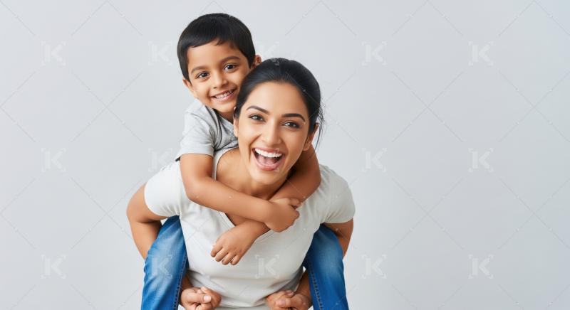 Joyful Indian mother and son sharing a fun piggyback ride