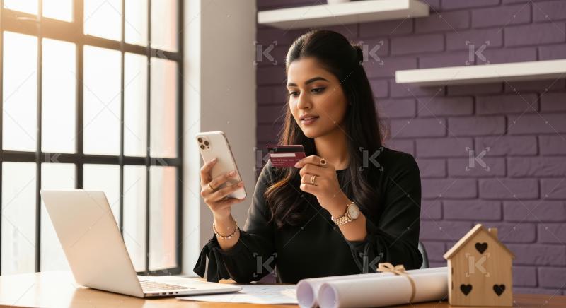 Young Indian woman making an online payment with a credit card a
