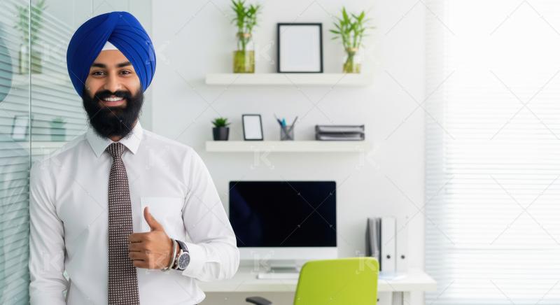 Confident and friendly Sikh professional in a white shirt and bl