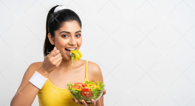Happy Young Indian Woman Enjoying a Fresh Healthy Salad Meal