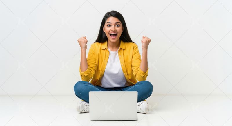 Excited Young Woman Celebrating Success While Using Laptop