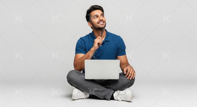 Young Indian Man Brainstorming New Ideas with Laptop