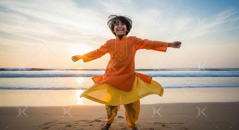 Joyful Indian Boy Spinning on Beach at Sunset