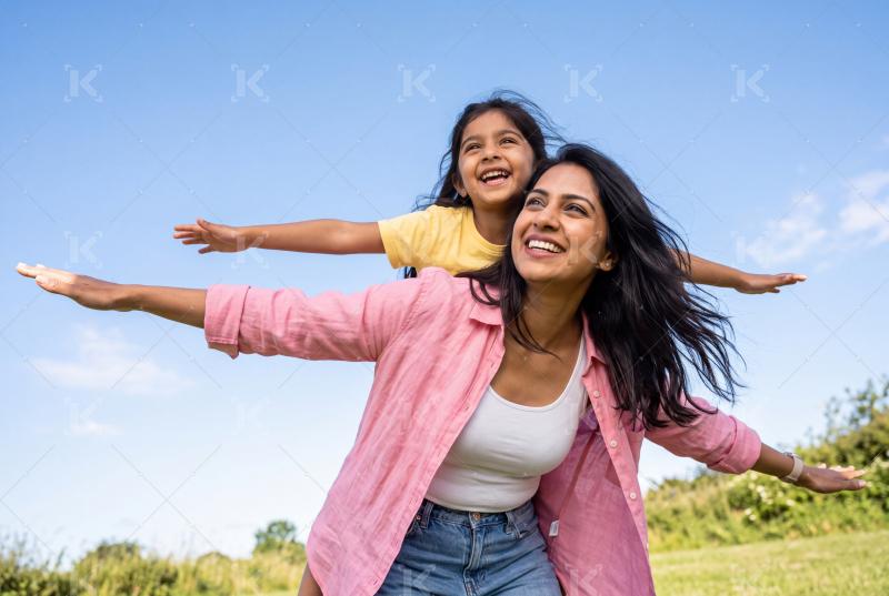 Happy young indian mother and daughter enjoying together at park