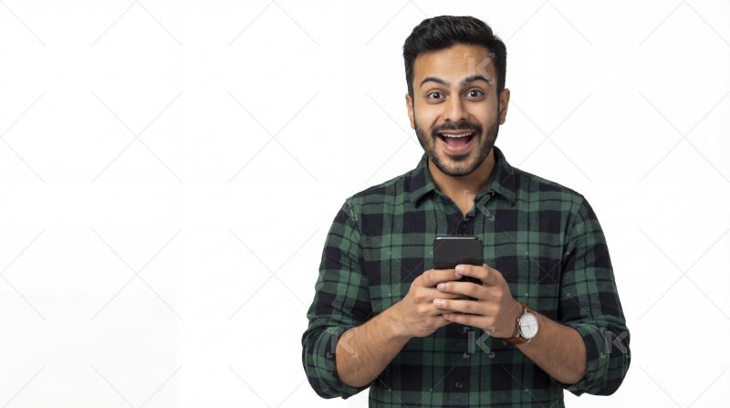 Excited young man happily using smartphone with a surprised expr