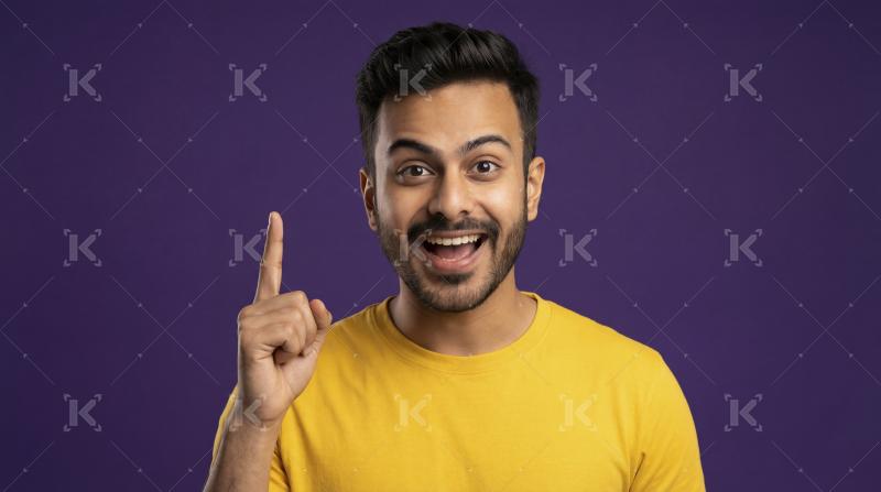 Happy Young Indian Man Pointing Up with Great Idea
