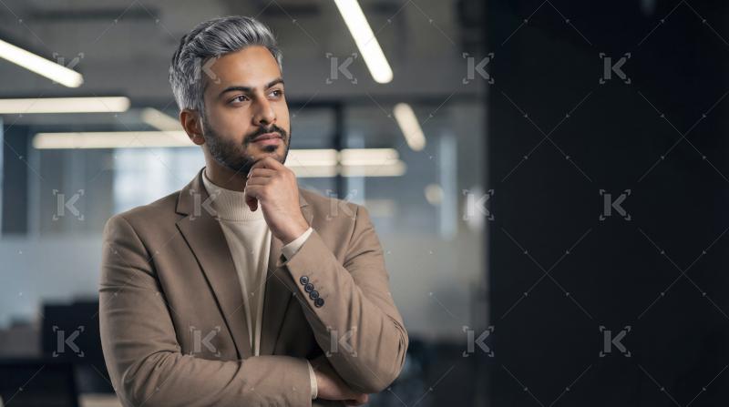 Thoughtful Businessman Pondering Ideas in Modern Office