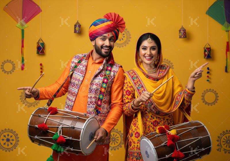 A man and woman in vibrant traditional attire pose with dhol dru