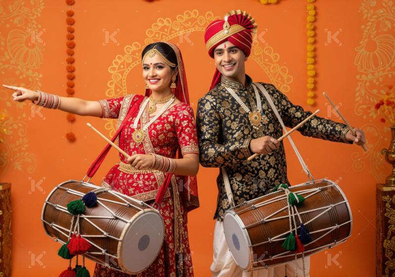 A man and woman in vibrant traditional attire pose with dhol dru