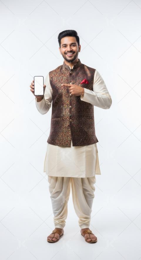 Young indian man wearing traditional kurta holding smartphone st