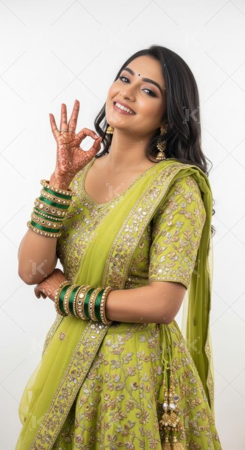 Young indian woman showing beautiful gesture with hand standing