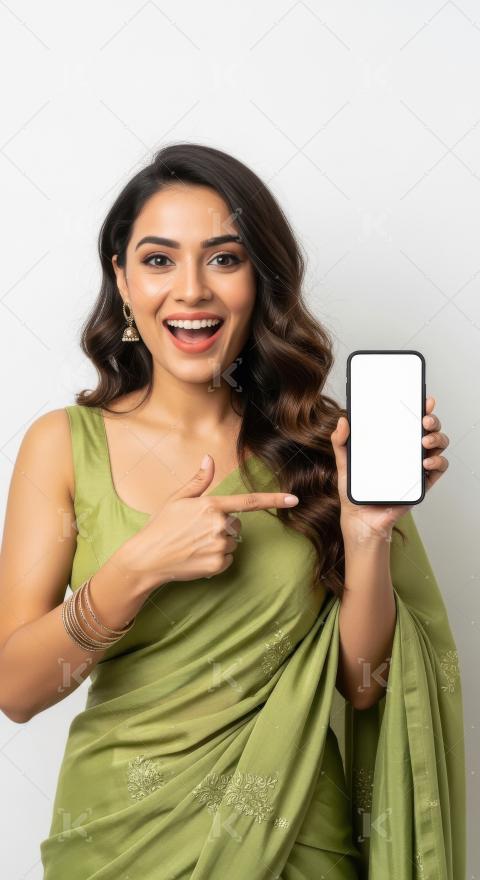 Young indian woman pointing with finger on blank mobile screen