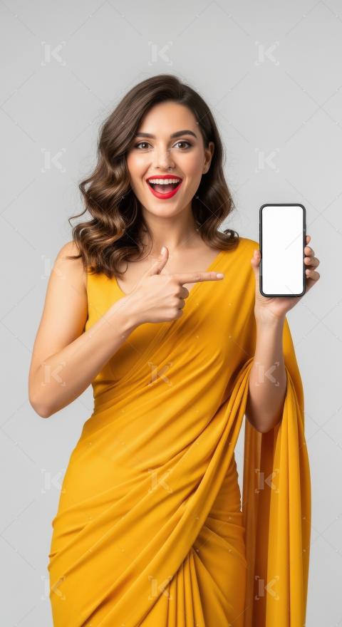 Young indian woman pointing with finger on blank mobile screen