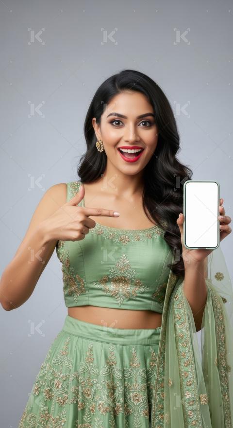 Young indian woman pointing with finger on blank mobile screen