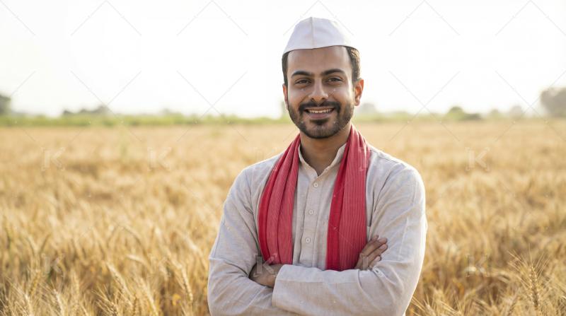 Happy Indian Farmer Smiling in Golden Wheat Field