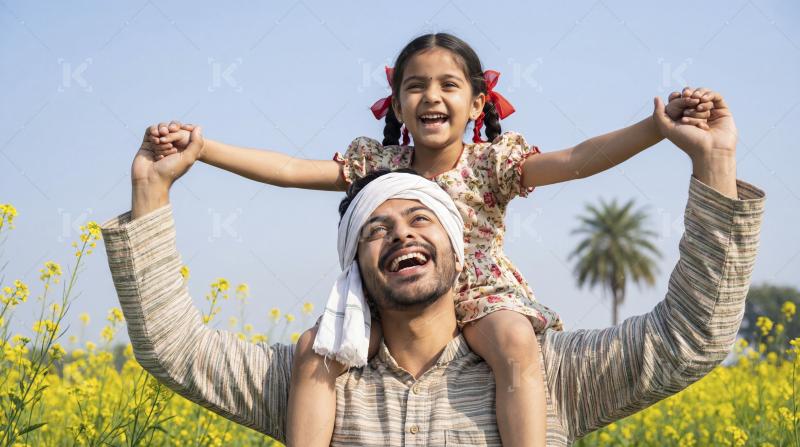 Indian Father and Daughter Laughing Joyfully in Mustard Field