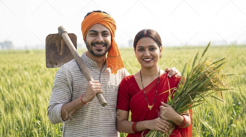 Happy Indian Farmer Couple with Harvest in Wheat Field